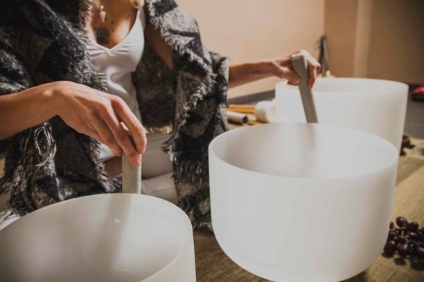 adult woman playing singing crystal bowl