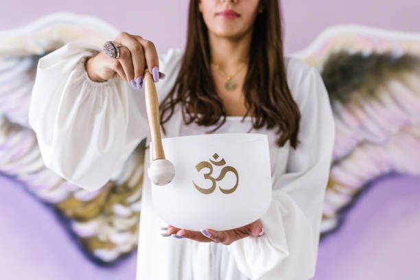 latin girl playing quartz singing bowl to meditate in latin america
